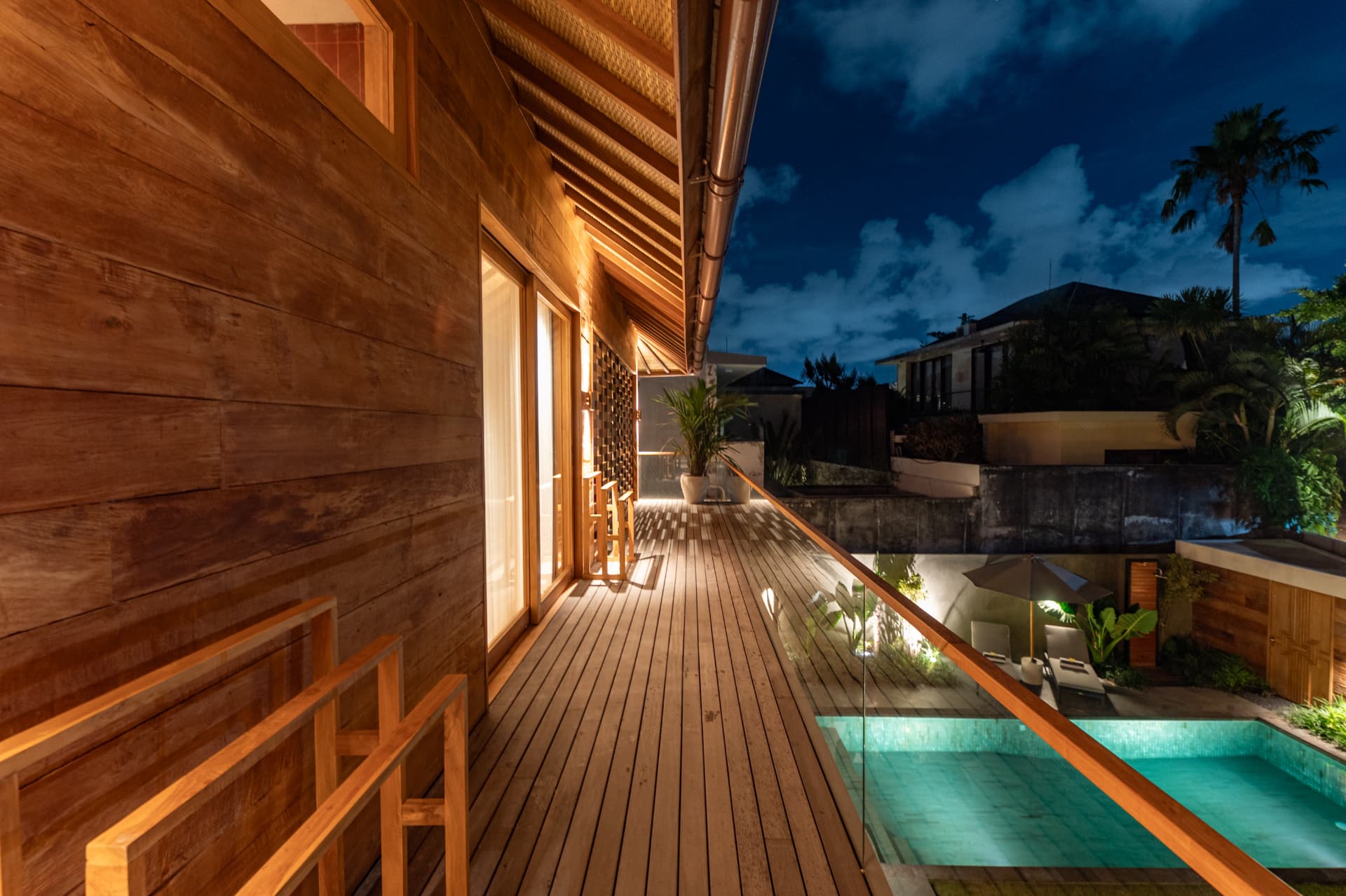 Umalas 1 — upper timber deck overlooking the pool at night