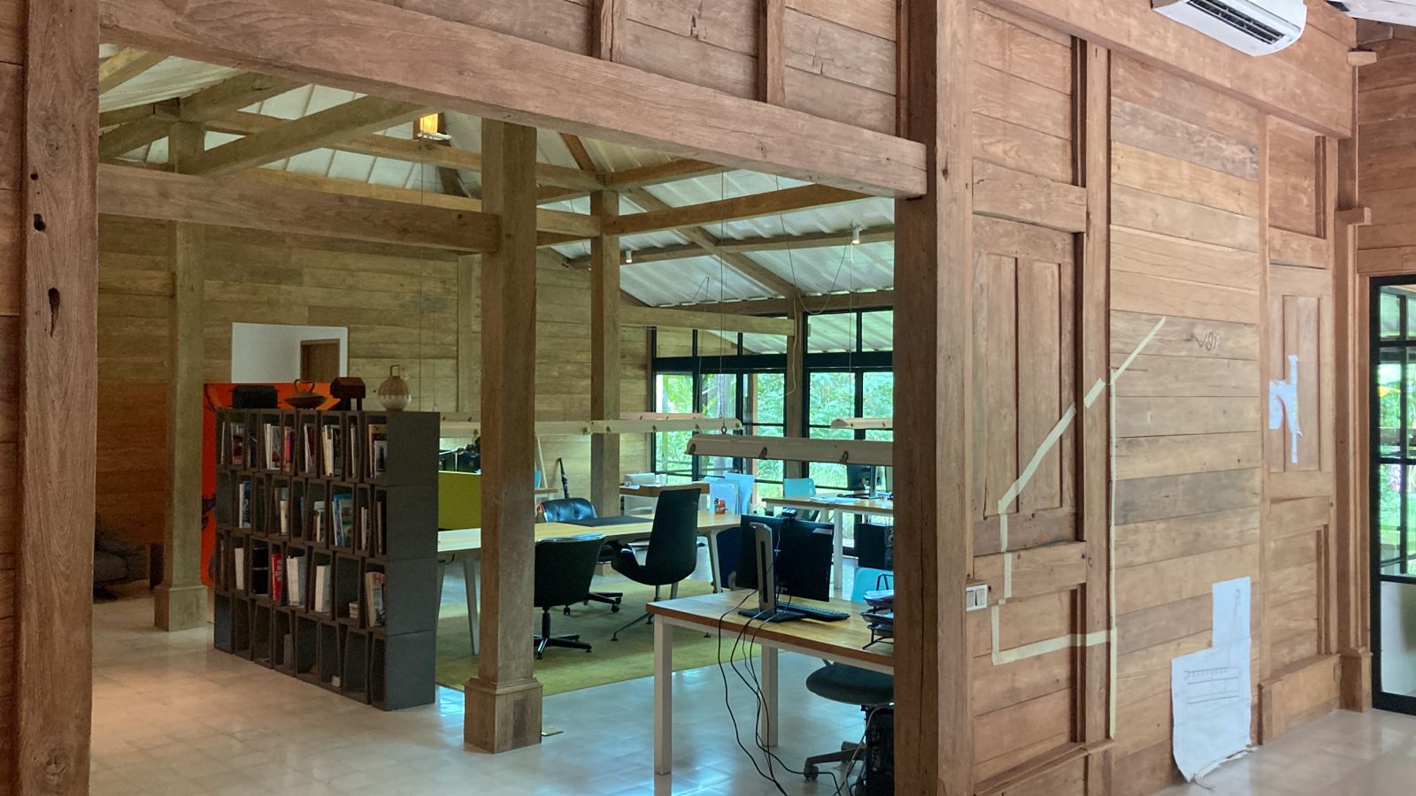 Ubud 3 — reclaimed teak wall and posts framing the interior volume