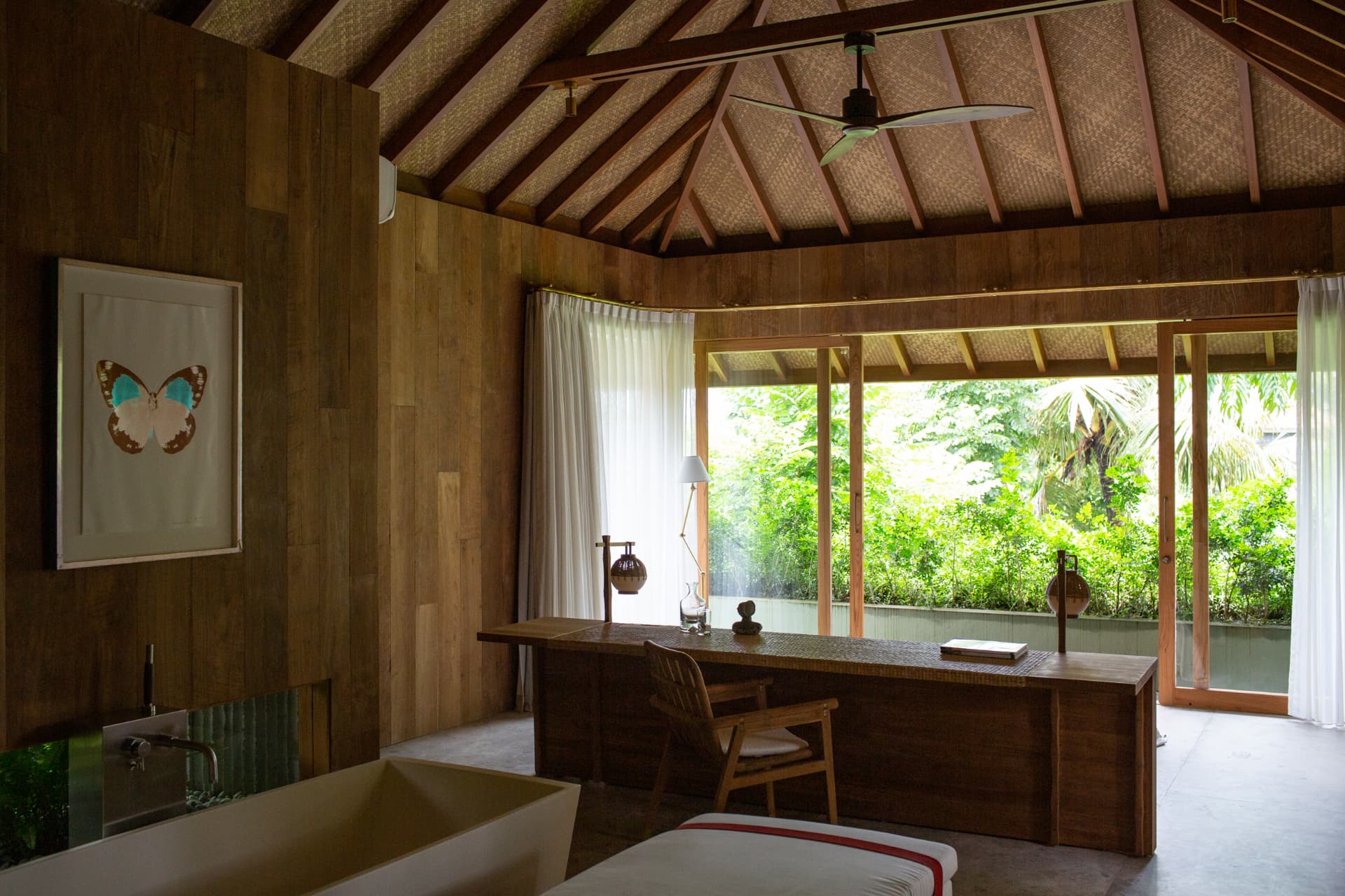 Ubud 1 — master bedroom with timber walls, woven ceiling and stone bath