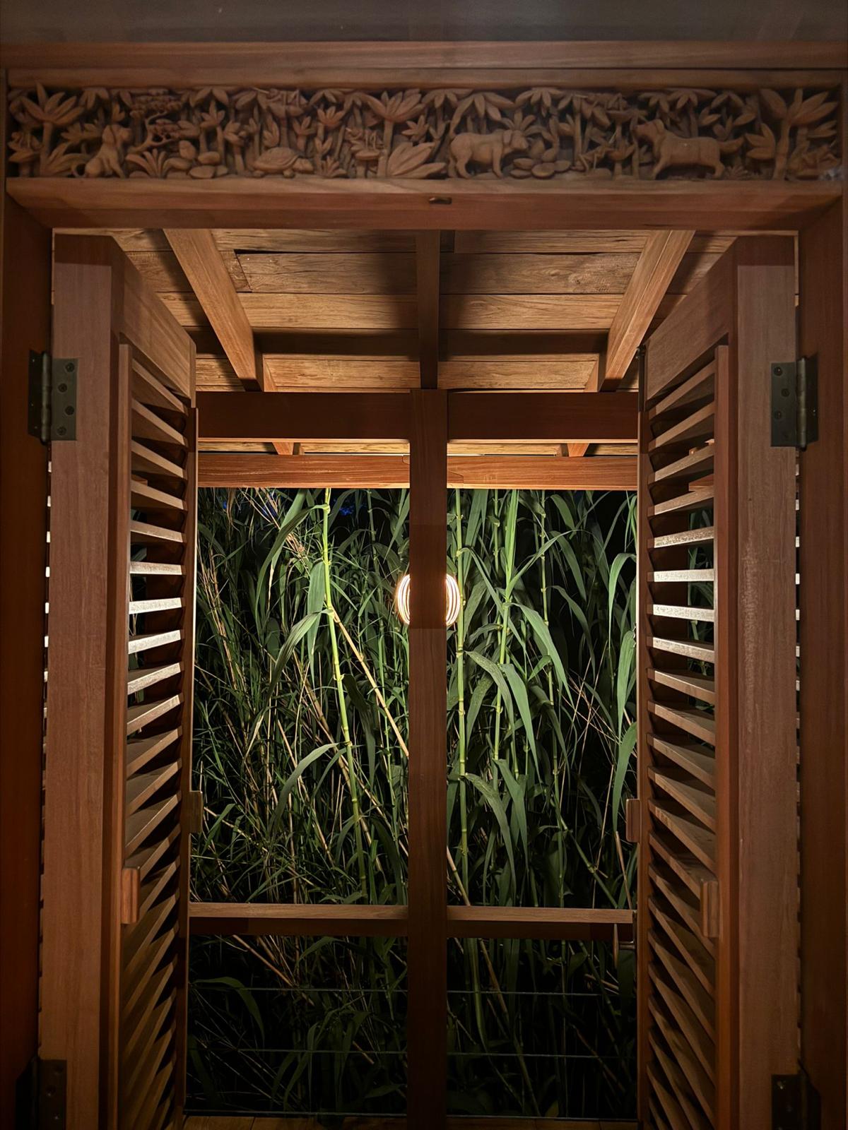 Tea House — carved timber lintel and louvred doors onto bamboo