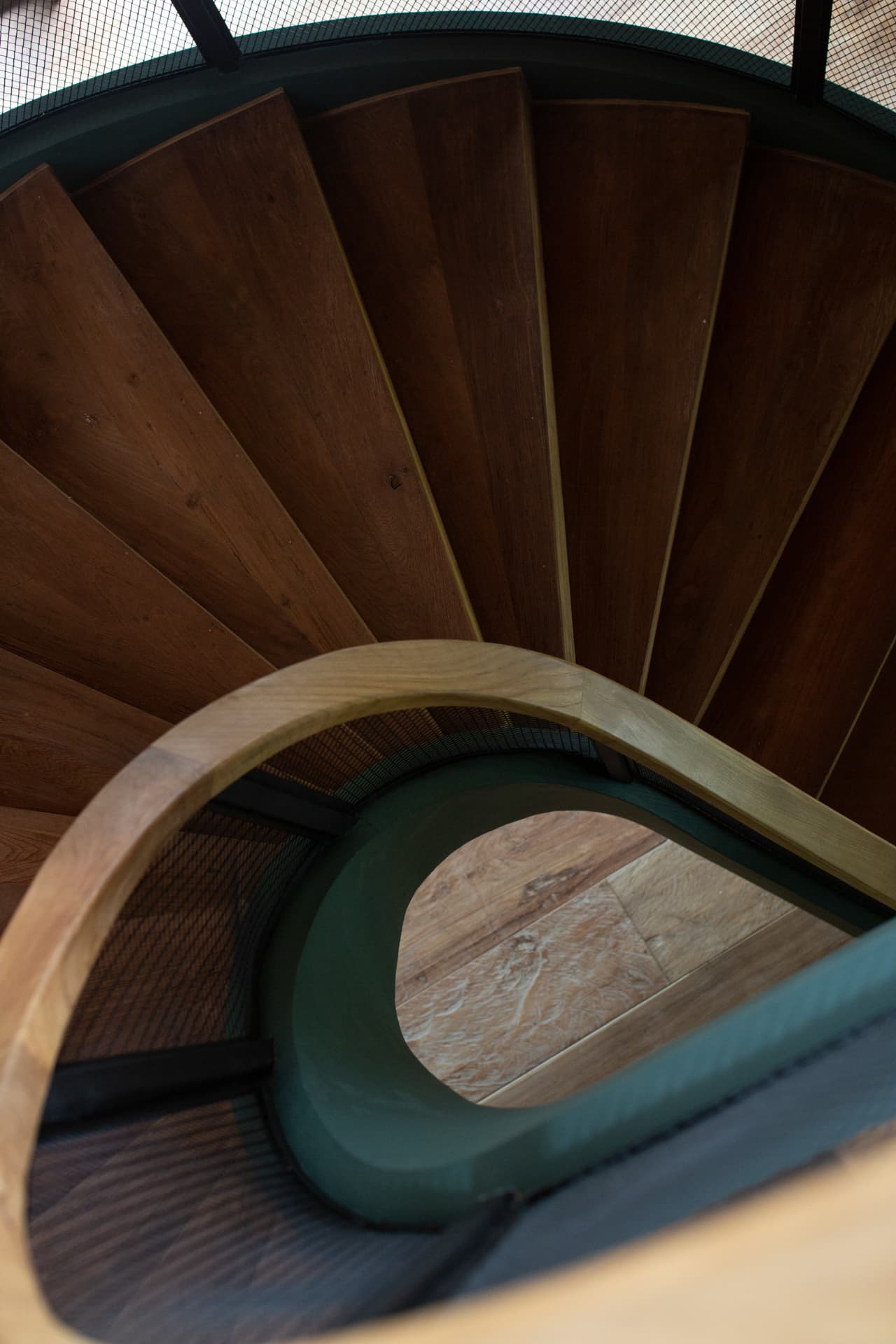 Detail of spiral timber stair treads and brass nosings