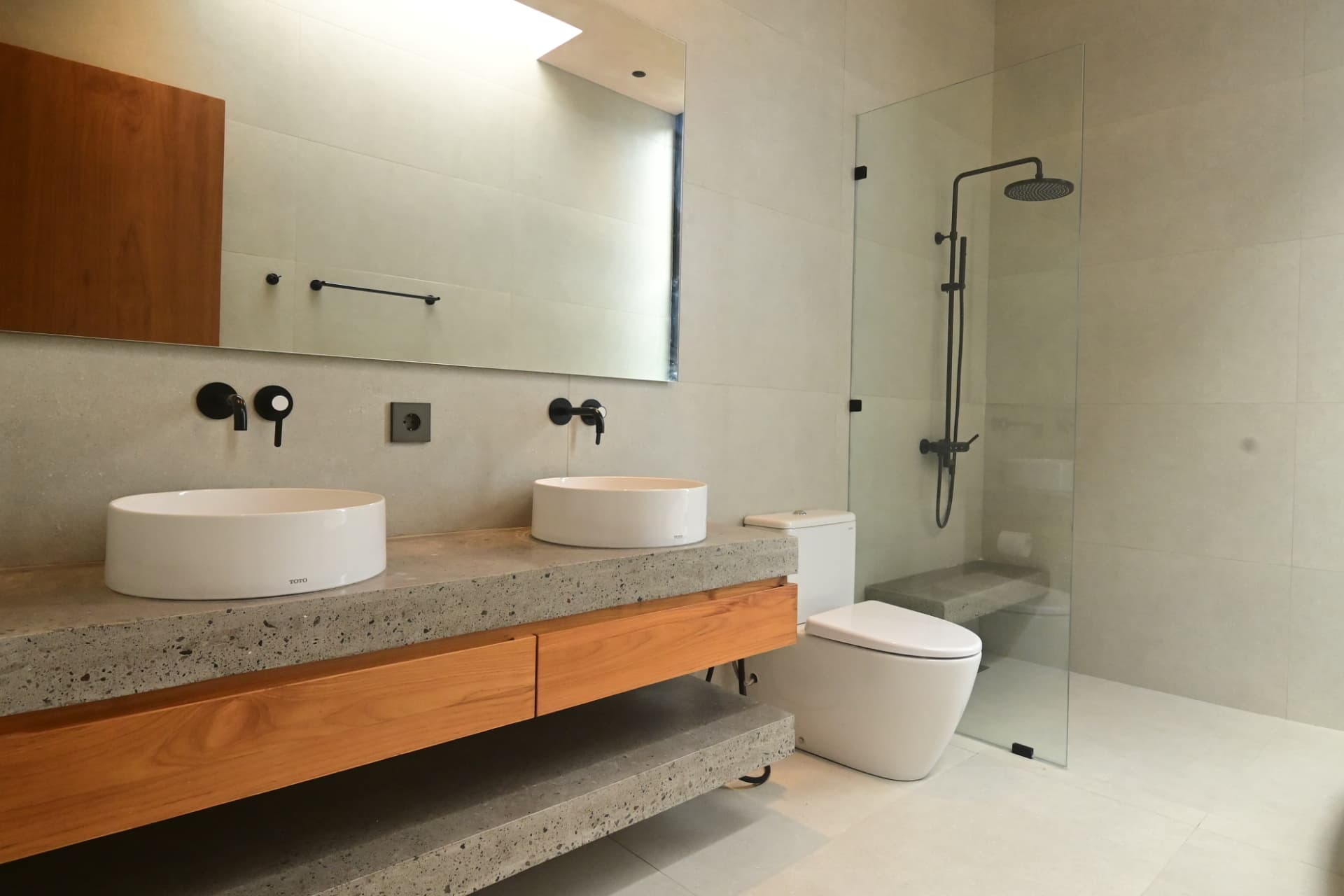 Pererenan 1 — master bathroom with terrazzo vanity and teak joinery