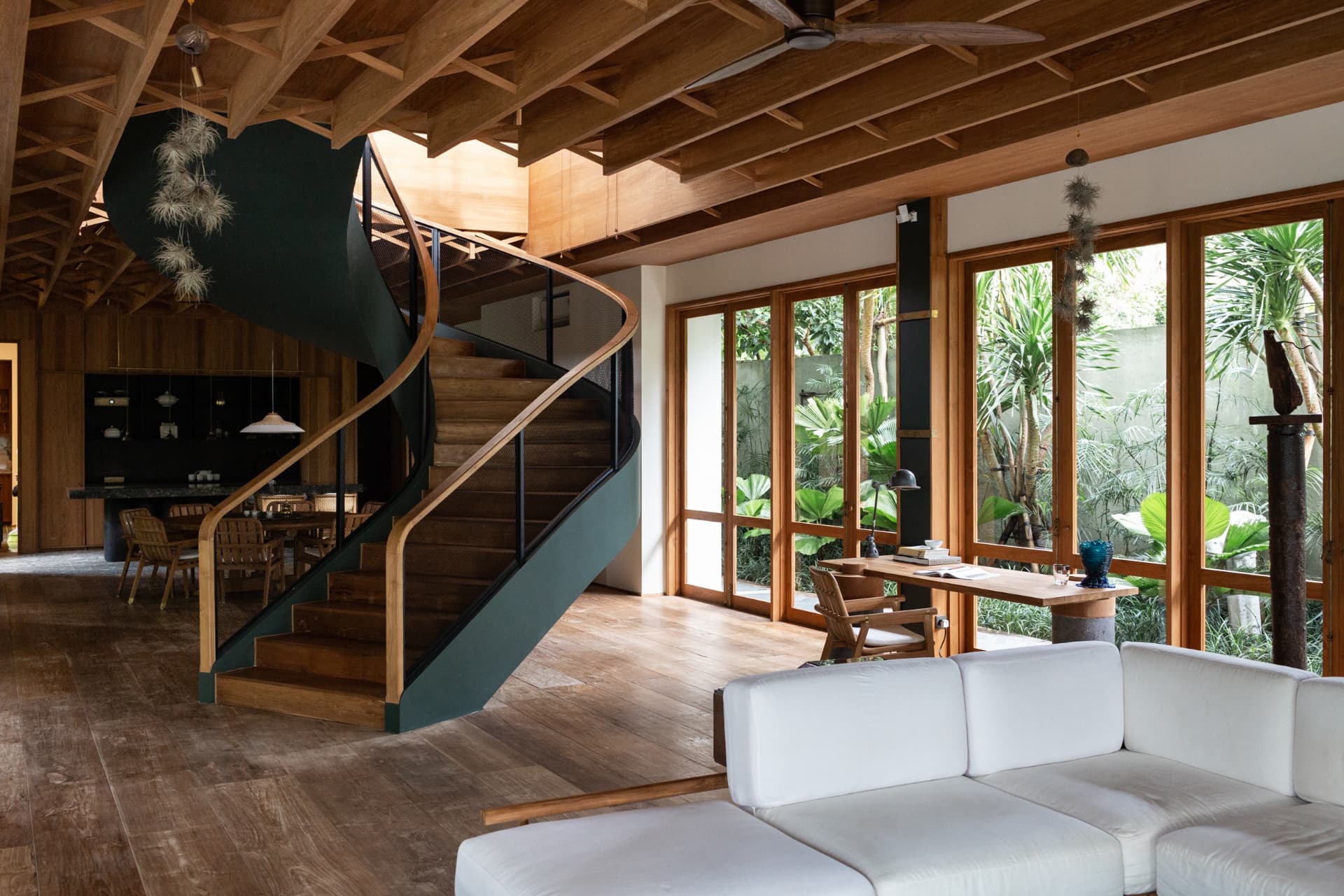 Curved timber staircase in a living volume