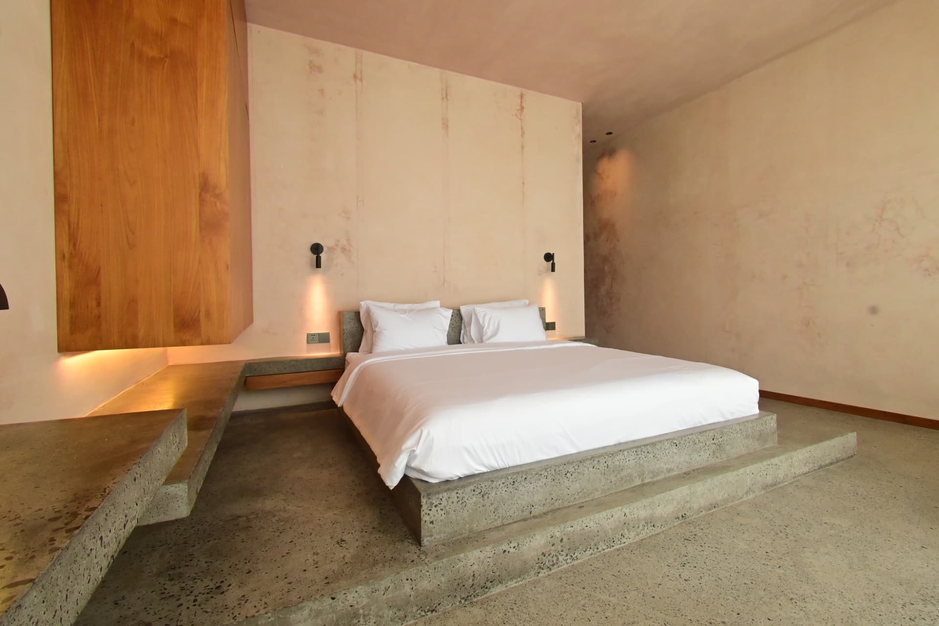 Pererenan 1 — bedroom with concrete plinth bed and plaster walls