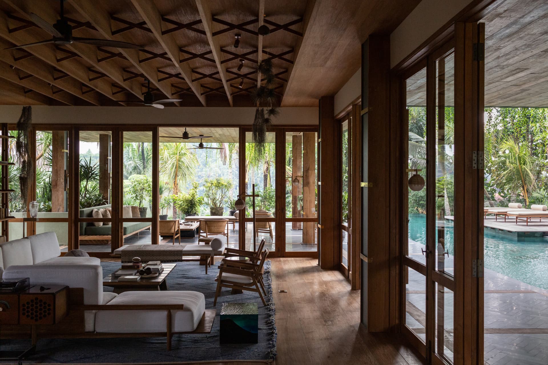 Living room with a coffered timber ceiling and pool view