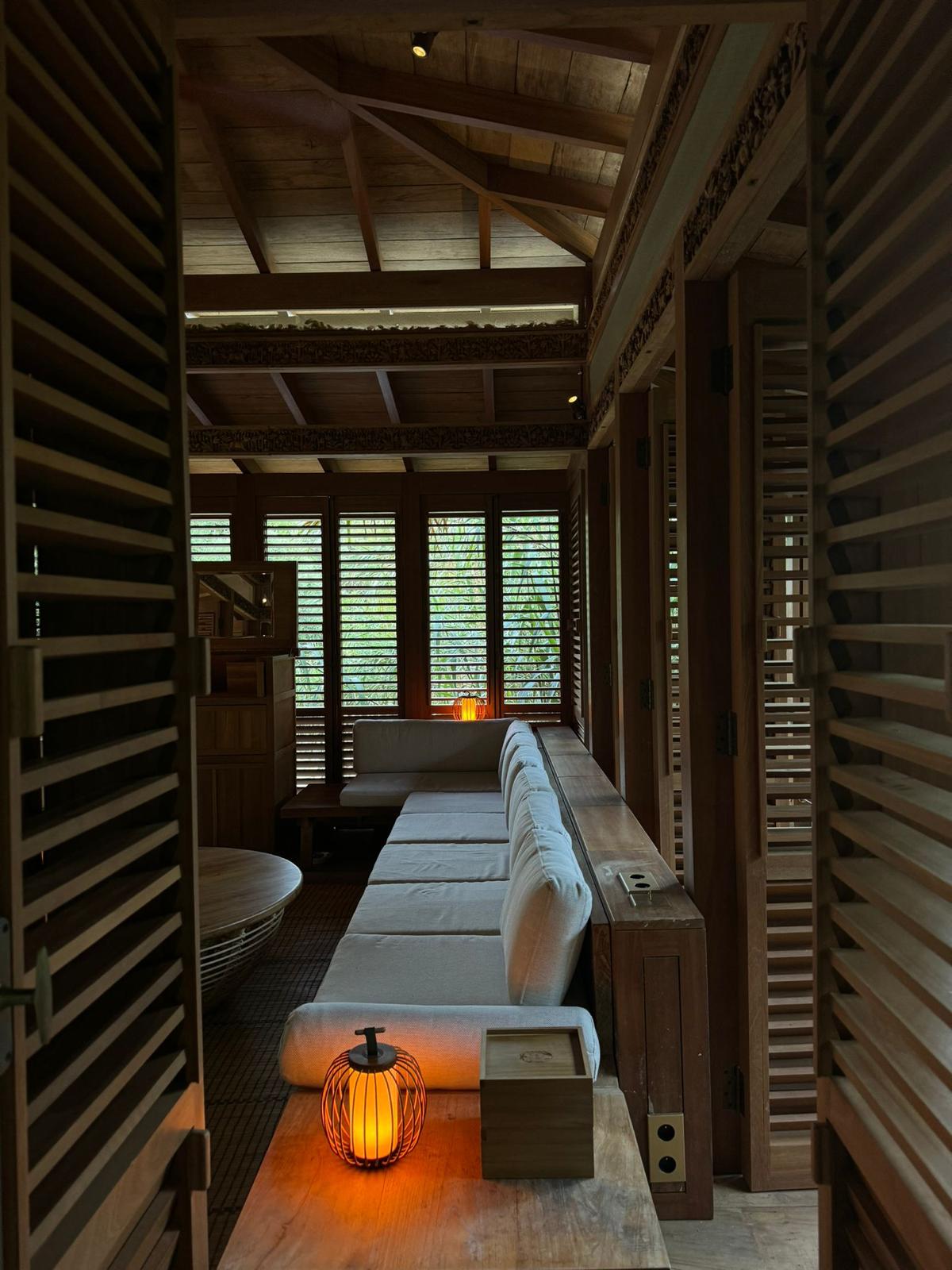 Tea House — interior bench seating under an exposed timber roof