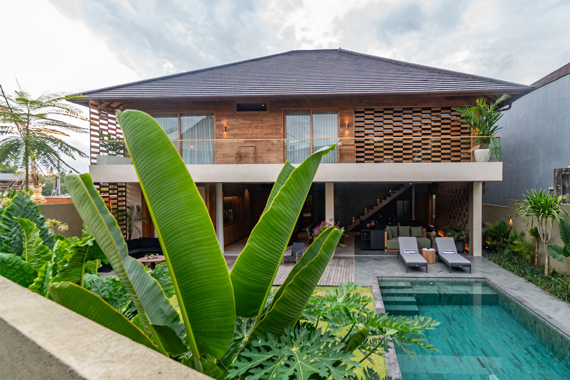 Umalas 1 — rear elevation with timber screens and pool at dusk