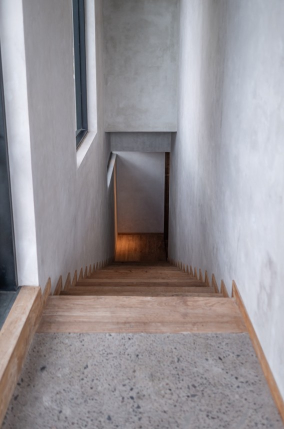 Timber stair detail in a plaster stairwell